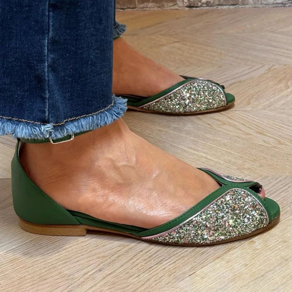 Stylish women's flat footwear; these elegant sandals feature a secure ankle strap for summer chic.