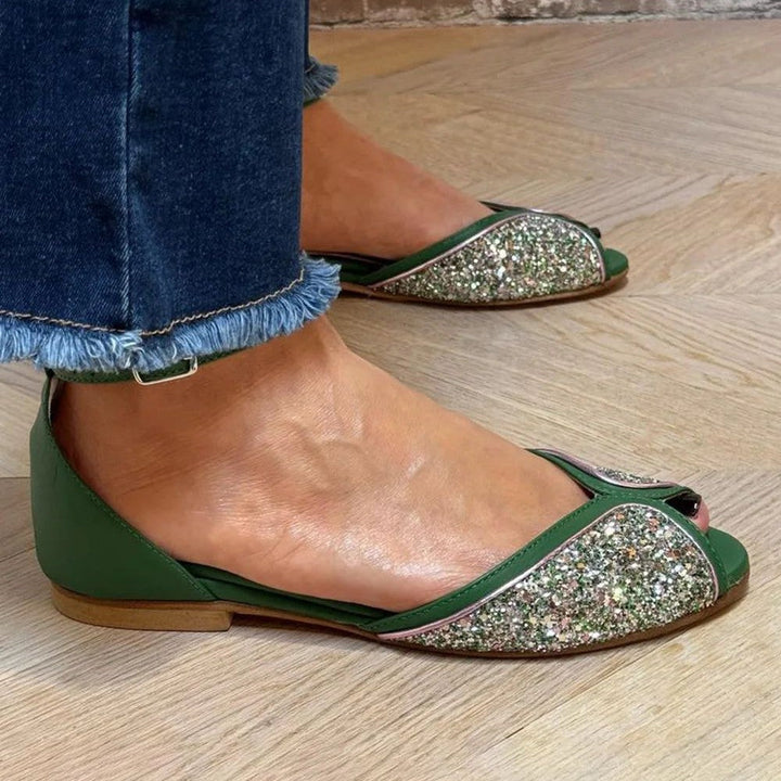 Stylish women's flat footwear; these elegant sandals feature a secure ankle strap for summer chic.