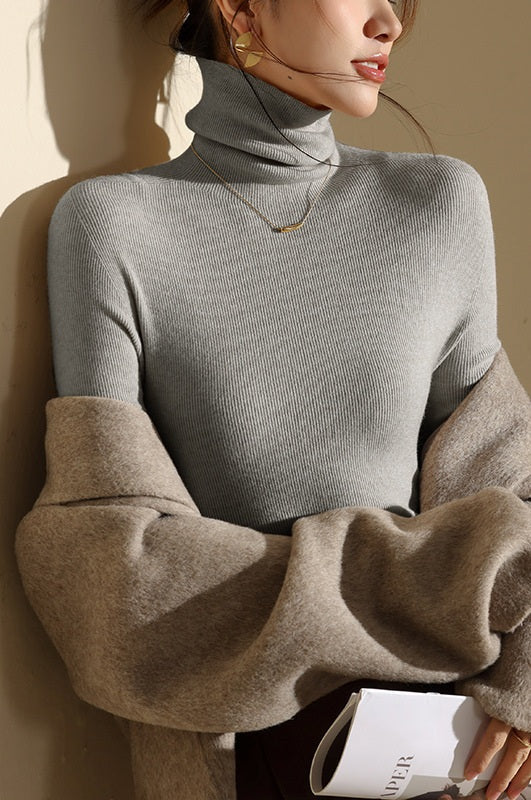 Elegant women's high neck seamless top, featuring a flattering slim fit and ribbed texture, ideal for layering.