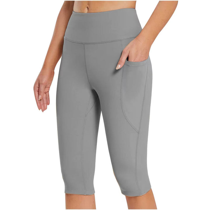 Modern women's sporty capri pants, high-waisted with functional side pockets for activewear.
