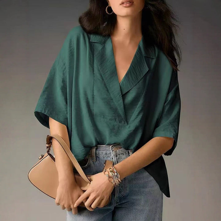 Chic V-neck workwear blouse for women. Elegant long sleeve top with a comfortable loose fit.