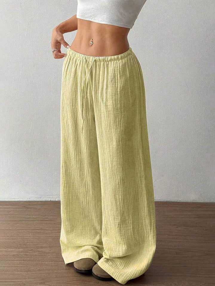 Soft women's wide leg flowy trousers with a drawstring. Comfortable casual wear, perfect for summer fashion.
