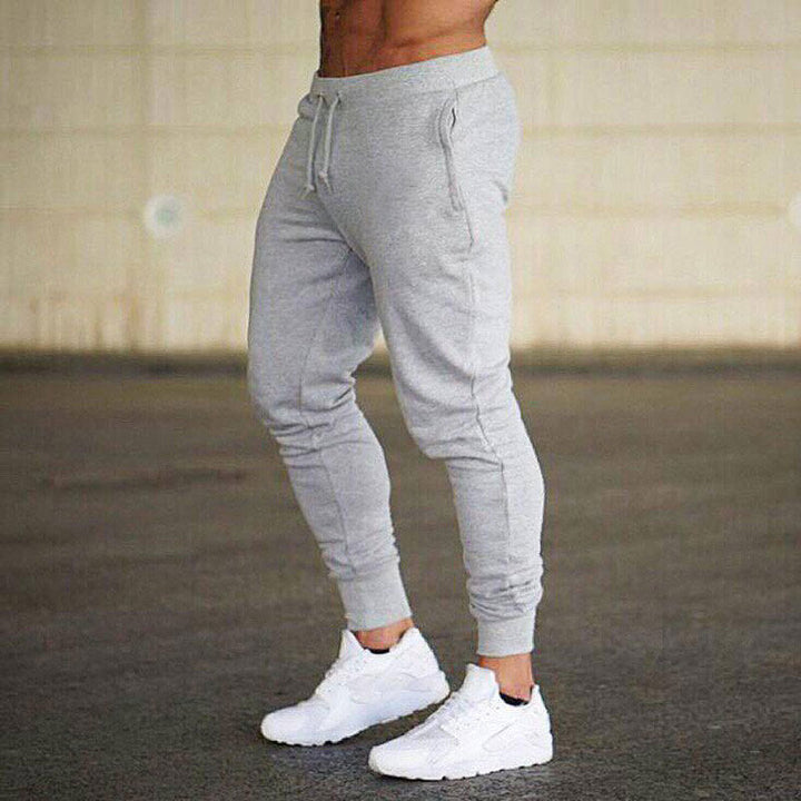 Man relaxing in casual comfort fit men's jogging pants, versatile for home or errands.