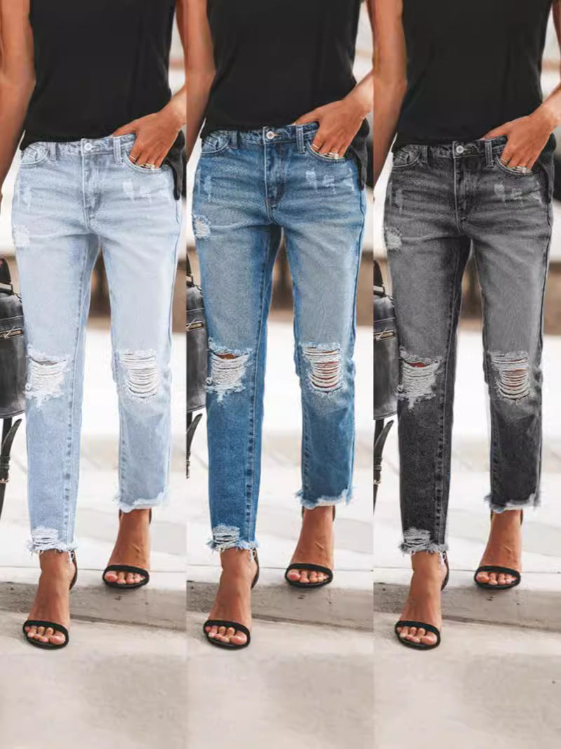 Women's casual ripped denim jeans with a stylish frayed hem. Perfect for everyday fashion and comfort.