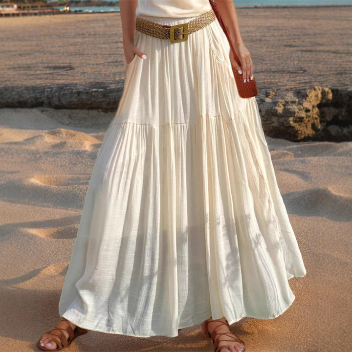Stylish women's maxi skirt featuring elegant pleats and convenient side pockets.