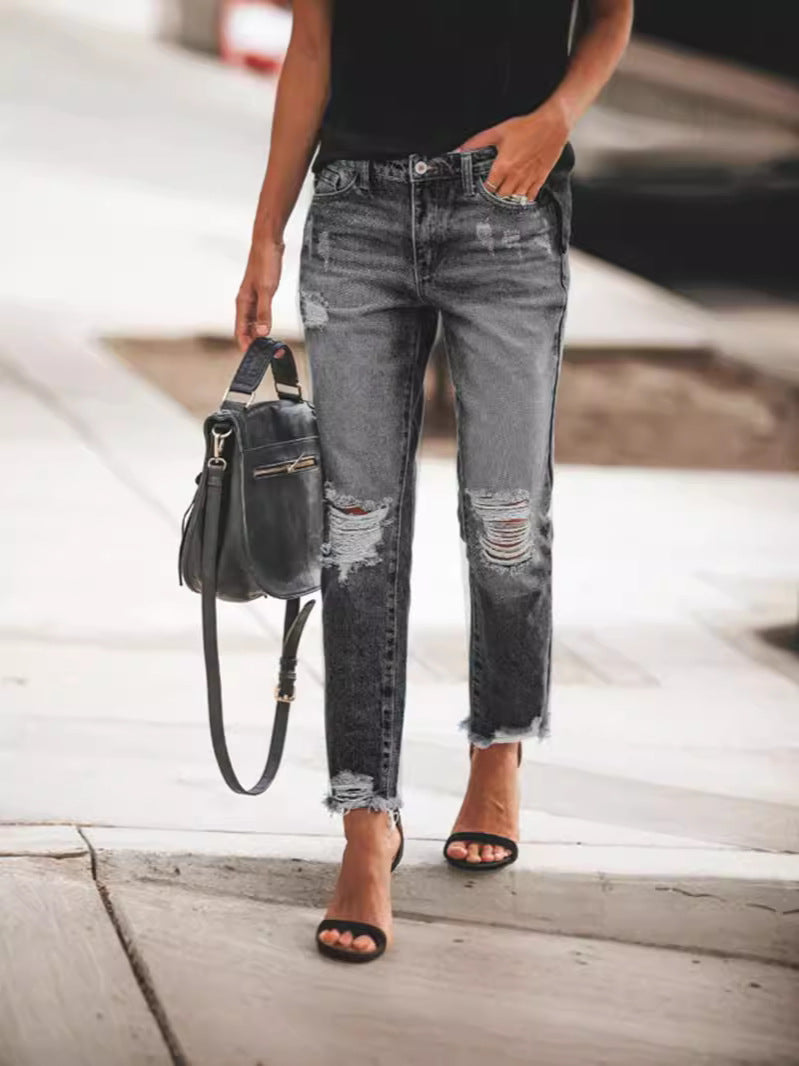 Comfortable women's casual jeans, light wash denim with cool rips and a distressed frayed hem detail.