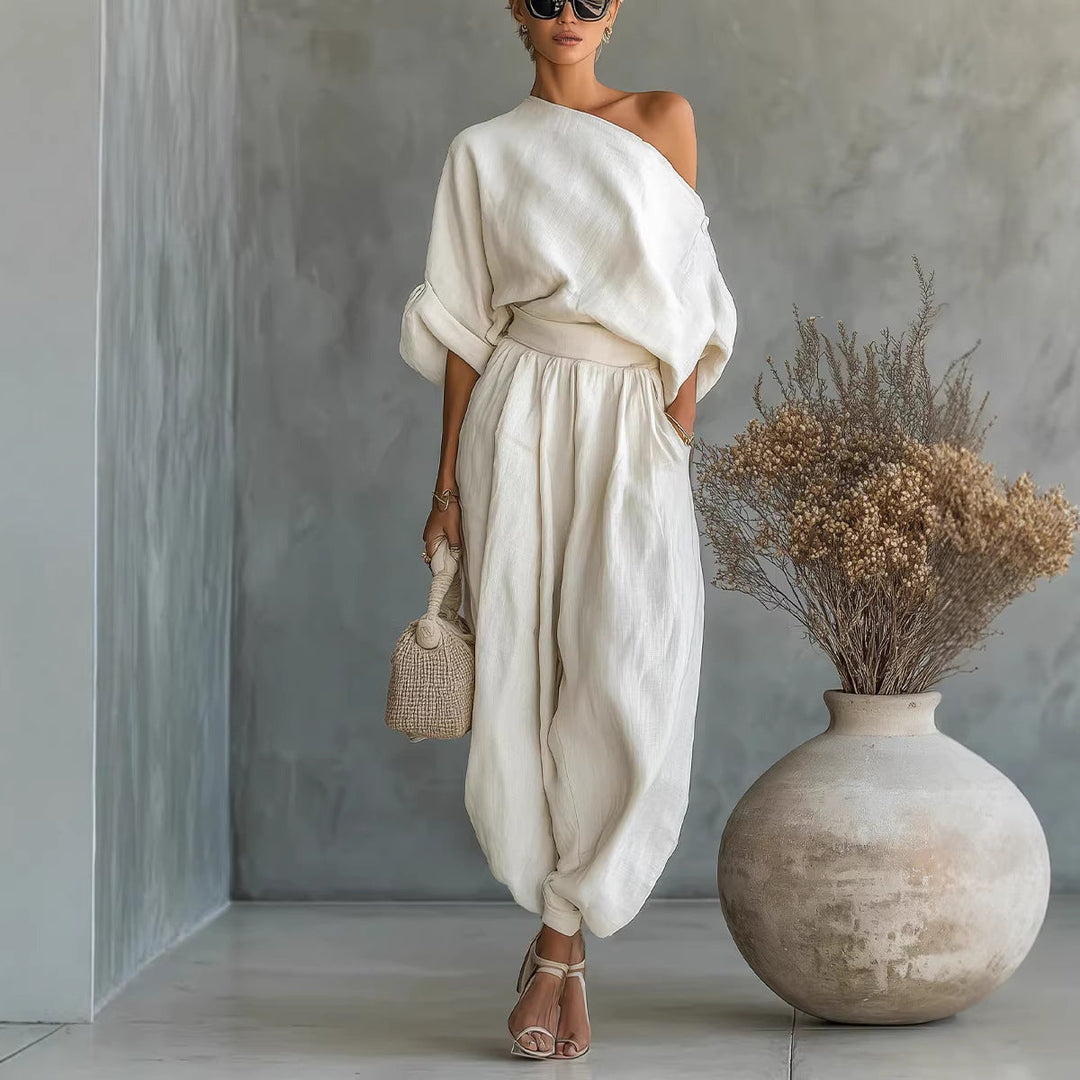 Stylish women's cream loose fit jumpsuit with an asymmetrical neckline, perfect for versatile summer outfits.