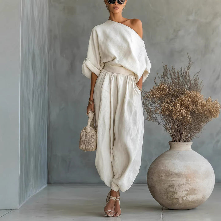 Stylish women's cream loose fit jumpsuit with an asymmetrical neckline, perfect for versatile summer outfits.