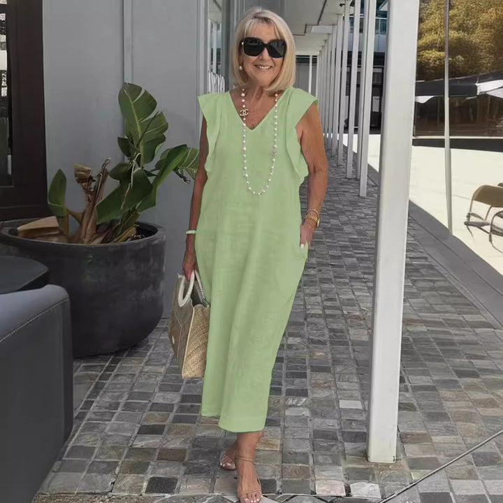 White flowy sleeveless summer dress for women, a comfortable and chic V-neck maxi ideal for casual elegance.