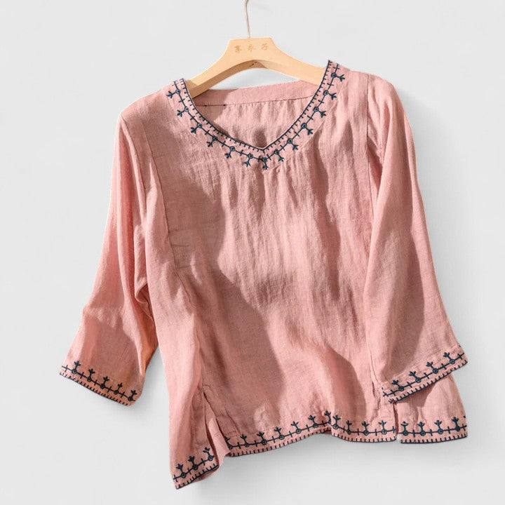 Stylish V-neck blouse for women, featuring delicate embroidery, ideal for elegant spring & summer wear.