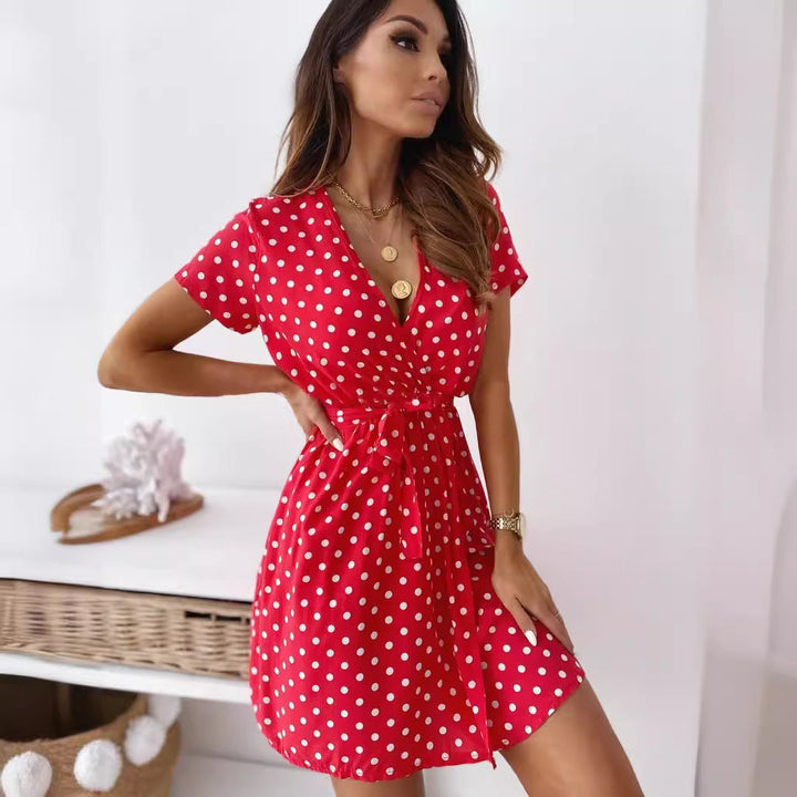 Elegant women's polka dot mini wrap dress, ideal for summer parties or chic daywear, features a flattering V-neck.