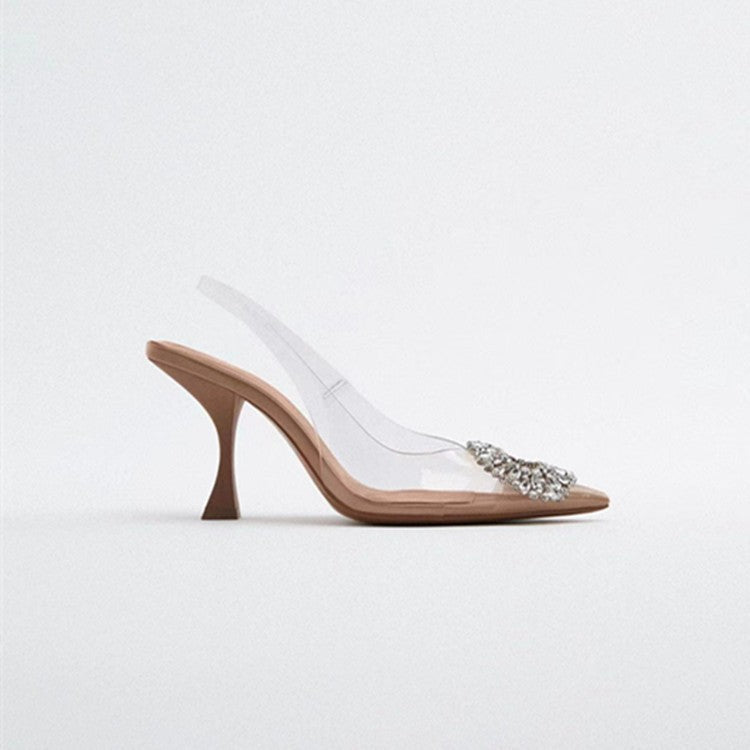 Fashionable women's transparent pumps, elegant clear shoes with dazzling jewel detail, formal footwear.