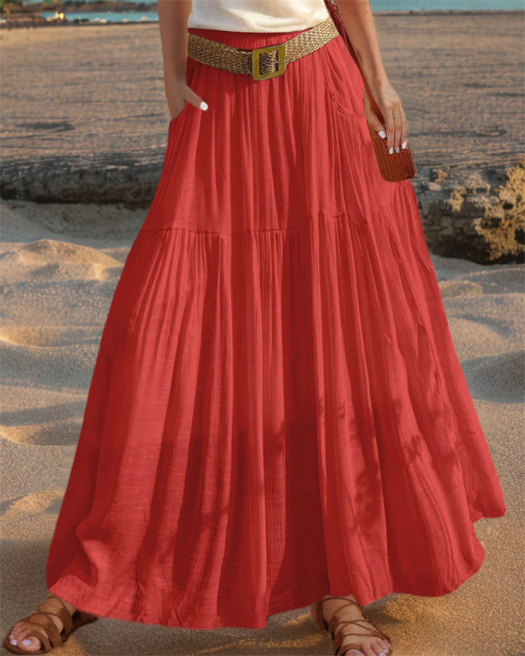 Women's elegant maxi skirt, pleated design with functional pockets for modern style.