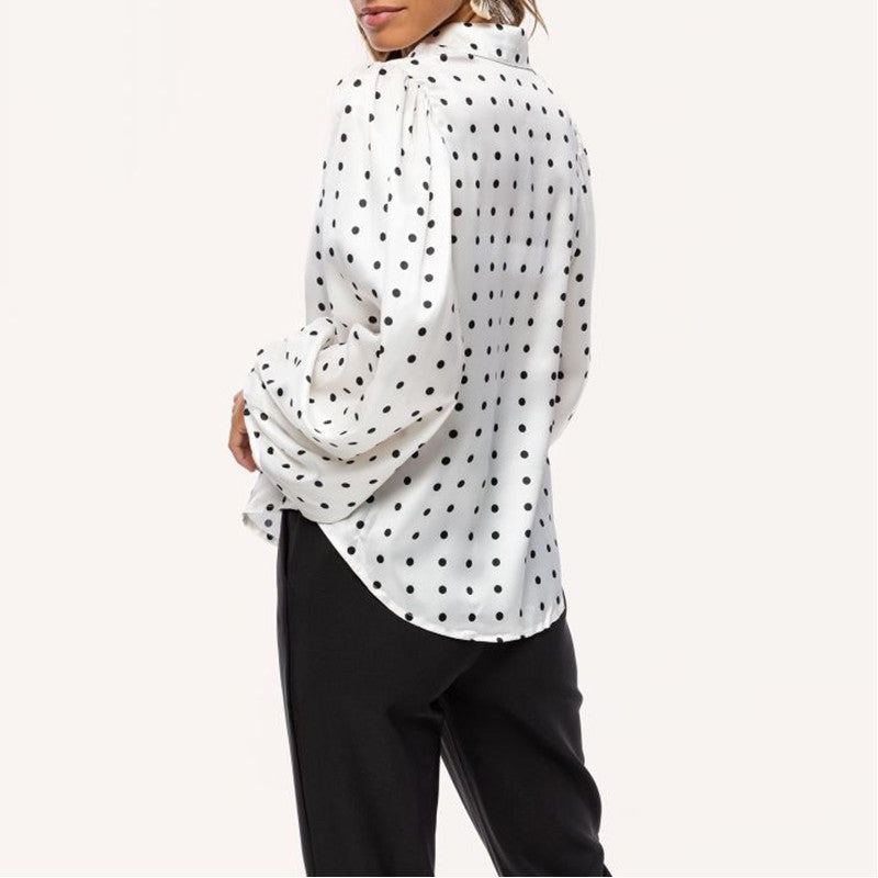 Fashionable women's long sleeve blouse featuring a polka dot print and trendy balloon sleeves. Chic and elegant top.
