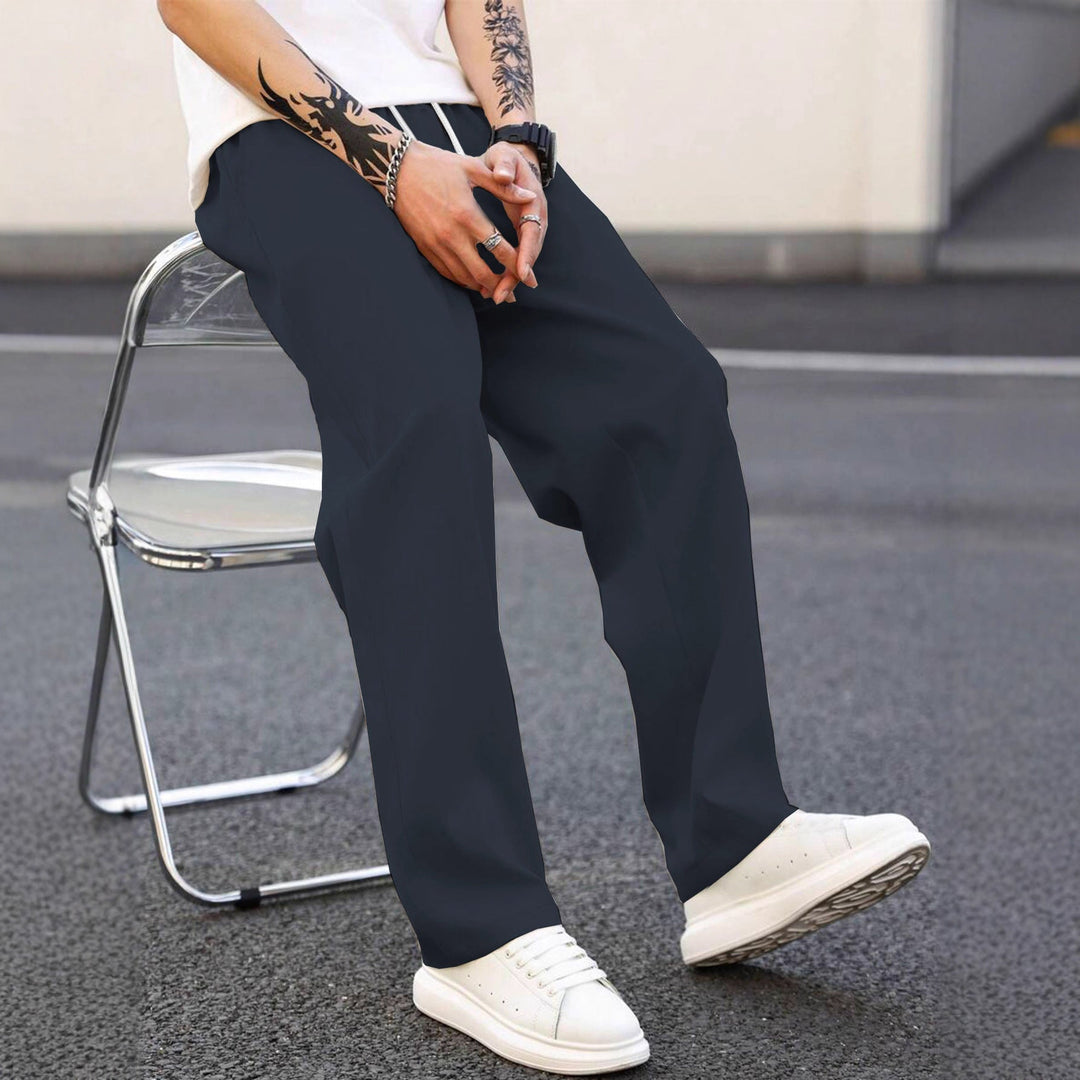 Side view of men's fashionable loose fit pants with elastic waist. Comfortable leisure wear.