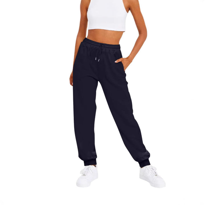 Tapered fit women's joggers featuring a soft elastic waist & practical side pockets for everyday comfort.