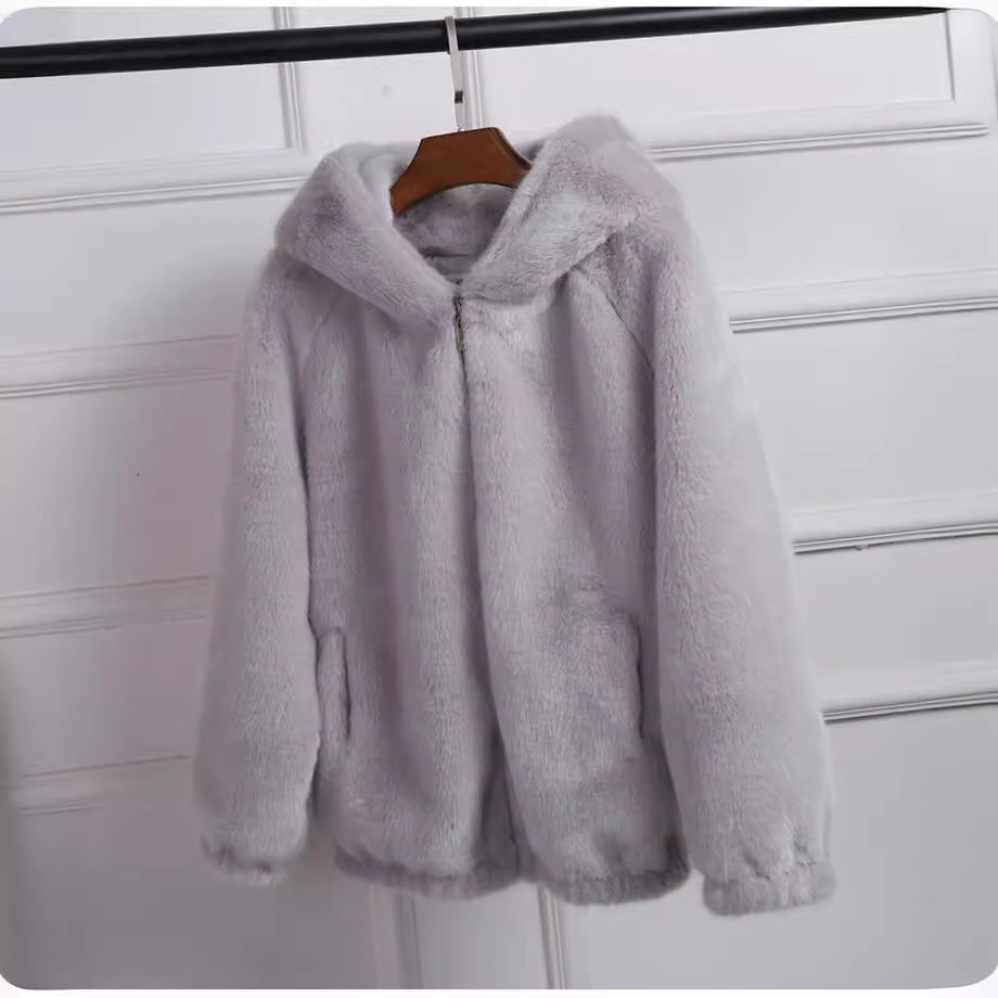 Chic women's hooded jacket offering stylish warmth. Ideal for casual layering in fall & winter fashion.