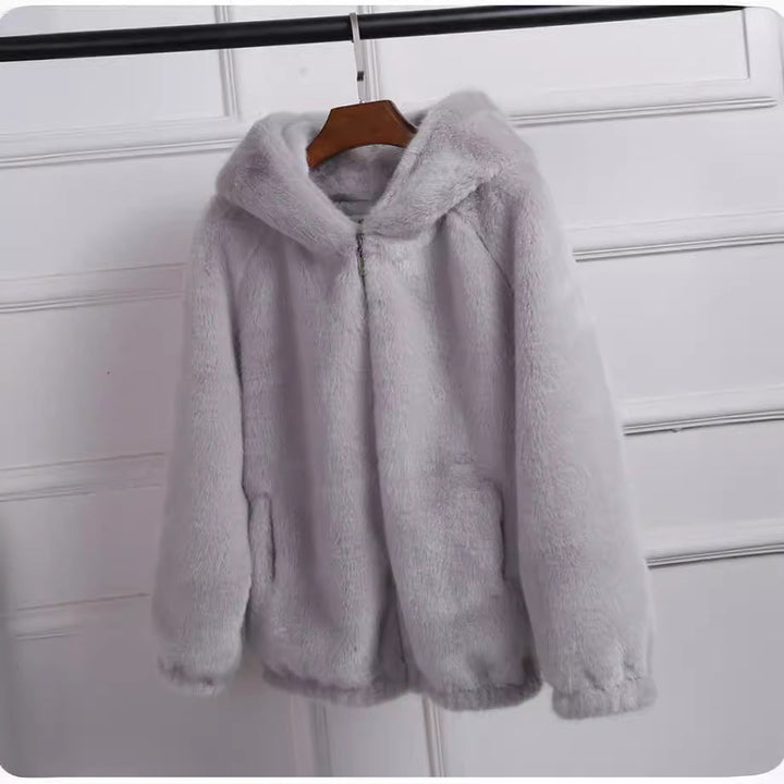 Chic women's hooded jacket offering stylish warmth. Ideal for casual layering in fall & winter fashion.
