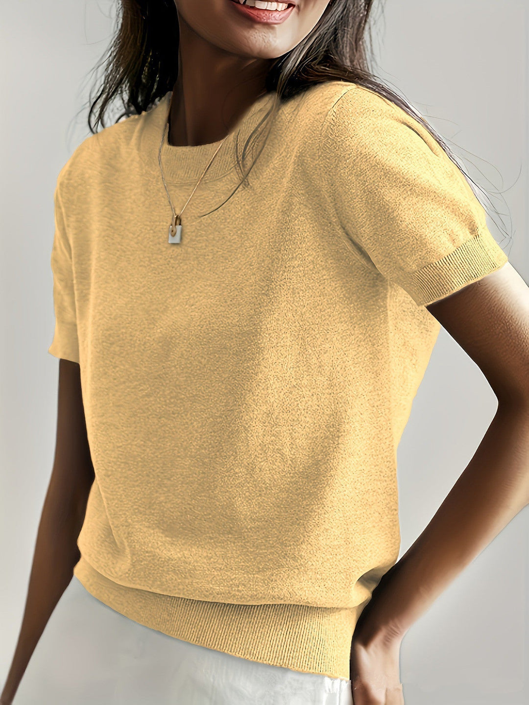 Effortless style: Women's elegant short sleeve knit sweater in a neutral hue.