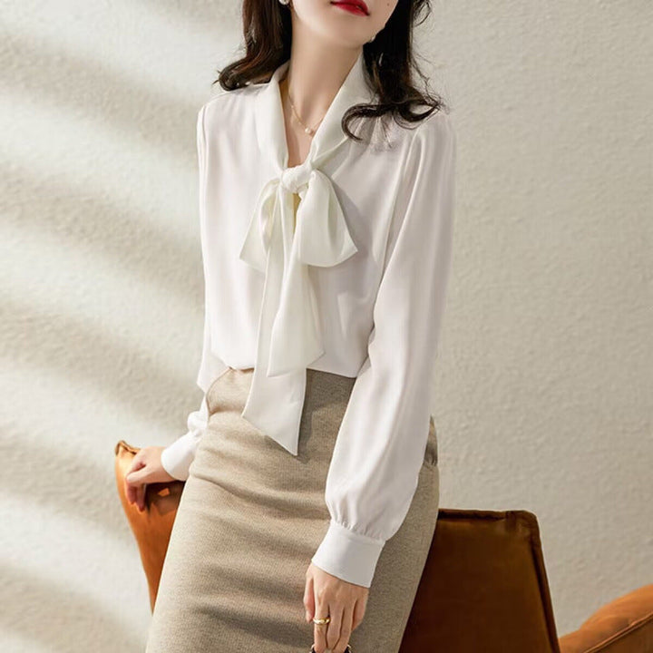Elegant women's white bow blouse, long sleeve, chic office wear top for a sophisticated look.