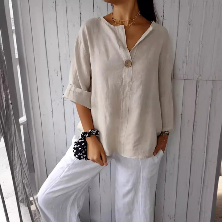 Lightweight women's button blouse, relaxed fit. Breathable casual top for warm weather.