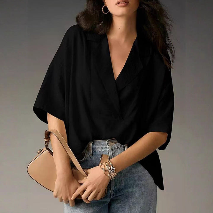 Loose fit women's V-neck blouse, ideal for everyday fashion. Comfortable long sleeve casual top.