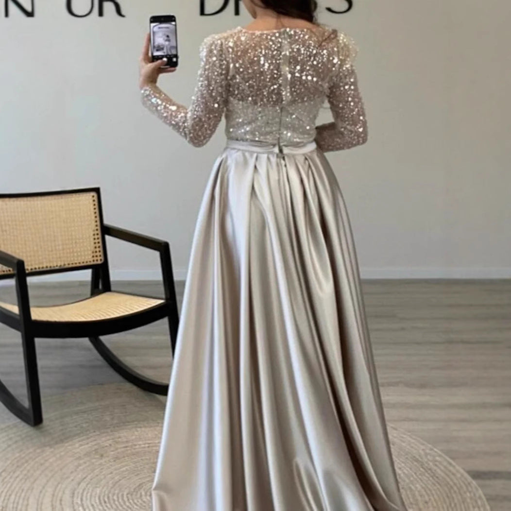 Elegant women's long-sleeve formal evening gown with shimmer detail. Ideal for special occasions.