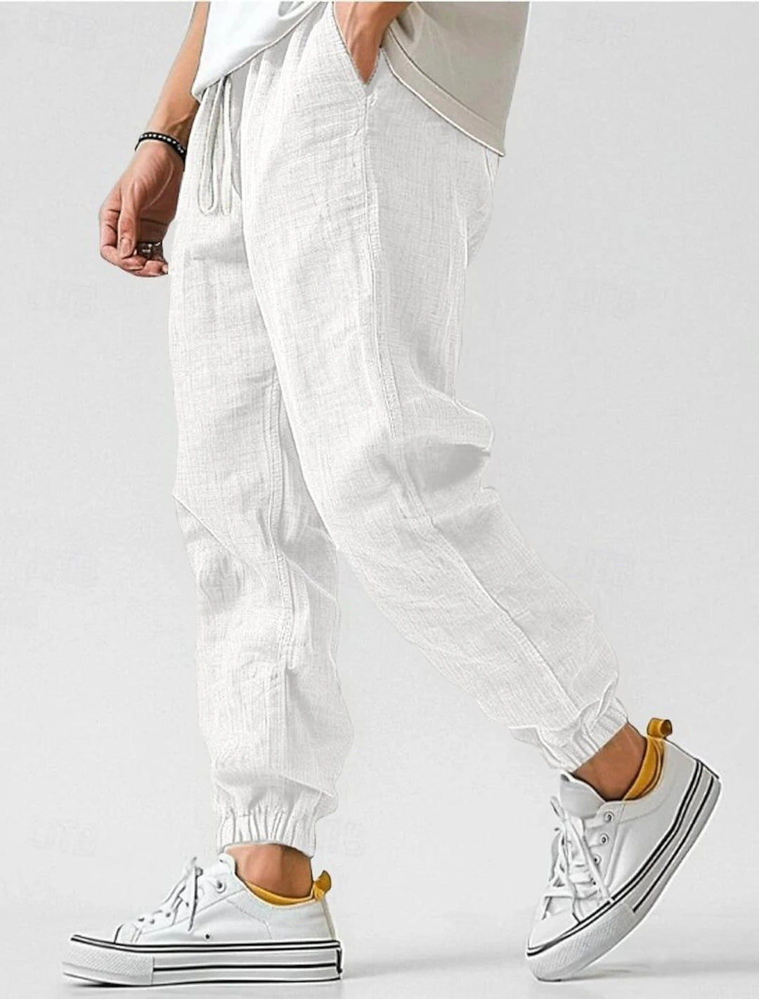 Men's fashion drawstring pants with an elastic waist, offering a relaxed fit & comfort.