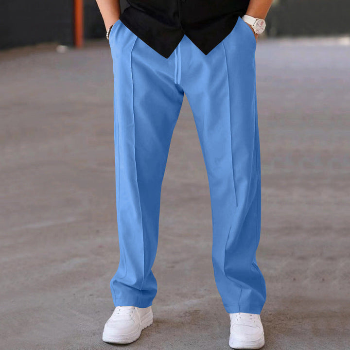 Side view of man wearing comfortable men's joggers, showing relaxed fit & modern casual pants.