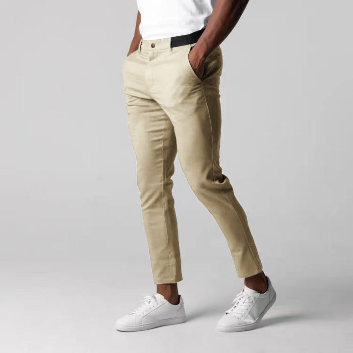 Detail shot: Men's slim fit chino pants, highlighting comfortable elastic waistband for modern casual style.