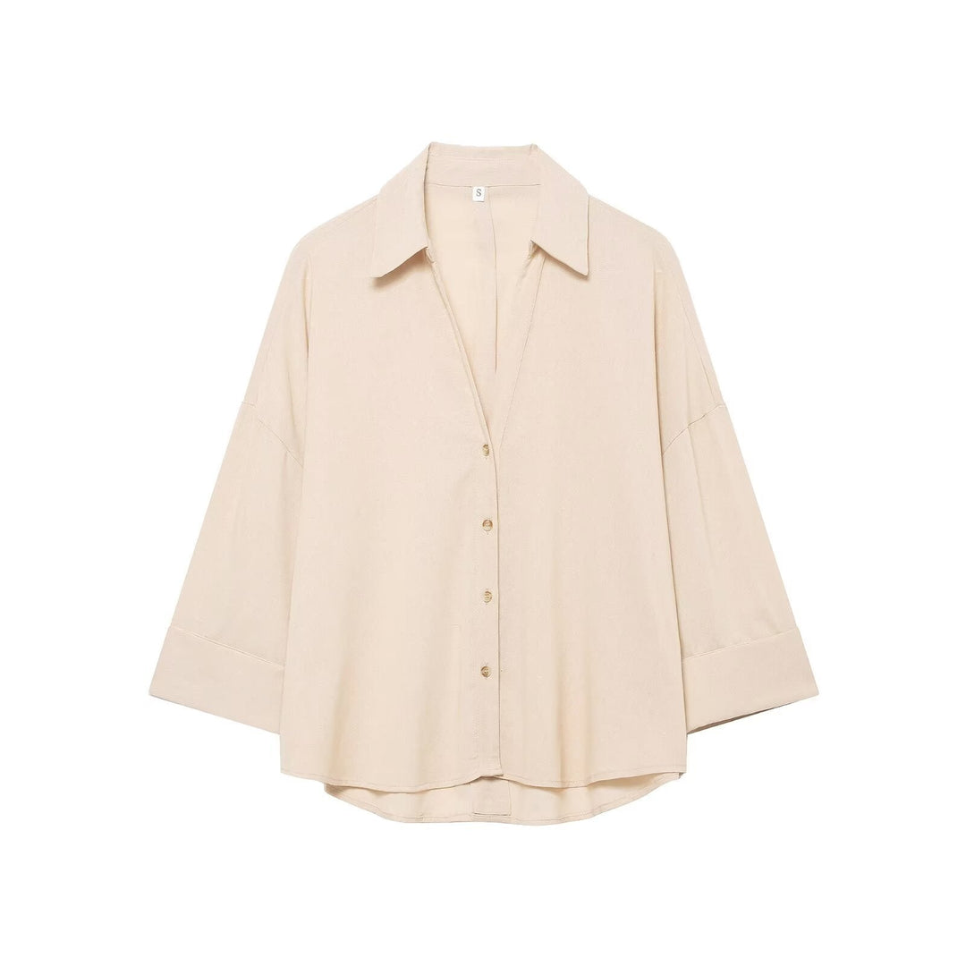 Women's loose-fit long-sleeve button-down blouse. Chic casual top for versatile spring fashion.