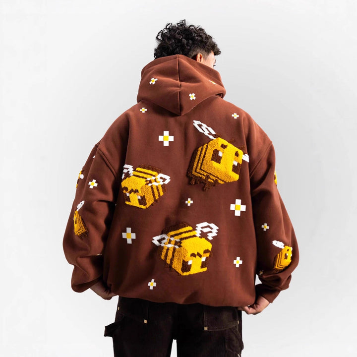 Chic women's light brown hoodie showcasing a detailed creative bee design, offering cozy and trendy comfort.