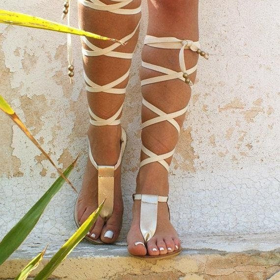 White women's flat strappy sandals. Open-toe gladiator style, adjustable for comfortable summer casual wear.