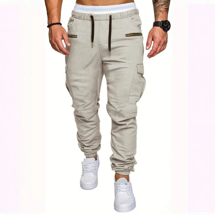 Casual men's sweatpants, cargo style, with elastic waist, slim fit, and secure zip pockets for everyday comfort.