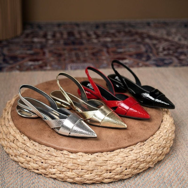 Chic women's formal silver slingback heels with metallic accents, pointed toe, and stiletto.