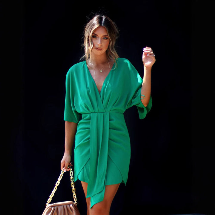 Fashionable party dress for women featuring an elegant V-neck and statement voluminous sleeves.