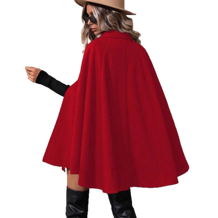 Luxury women's elegant double-breasted cape jacket with detailed buttons. Sophisticated tailored outerwear.