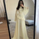 Women's sophisticated tiered maxi dress with statement bell sleeves for special occasions.