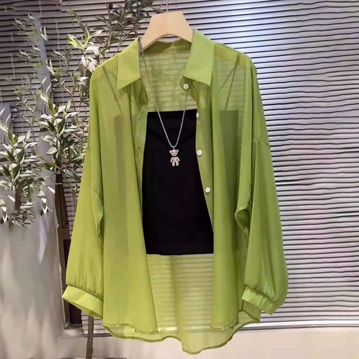 Versatile women's long-sleeve sheer button-down tunic. Stylish layered top for various elegant fashion looks.