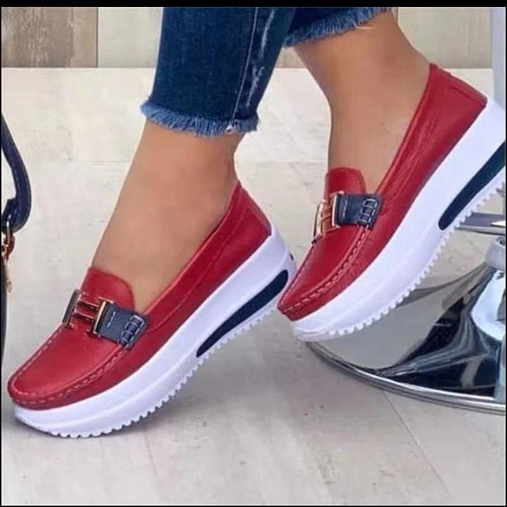 Versatile women's fashion loafers featuring a comfortable wedge heel and convenient slip-on design.