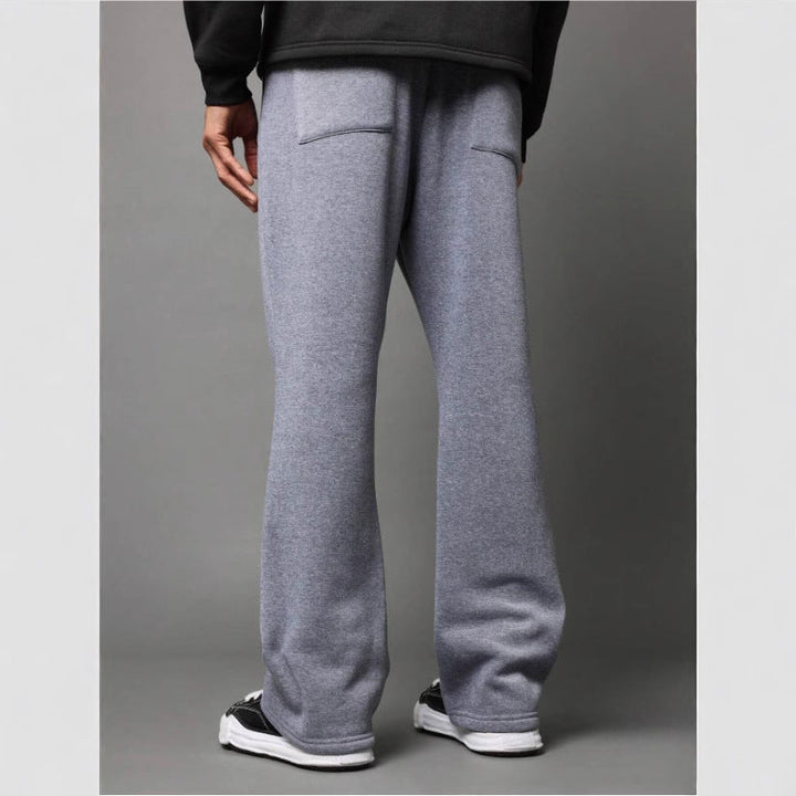 Comfortable men's flared sweatpants with a relaxed fit, ideal as stylish loungewear or casual trousers.