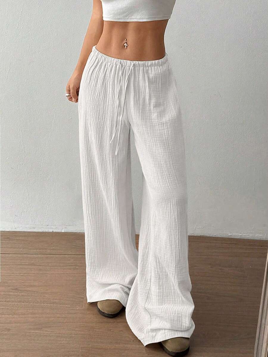 Versatile women's wide leg flowy pants for casual wear. Comfortable summer fashion bottoms, relaxed fit.
