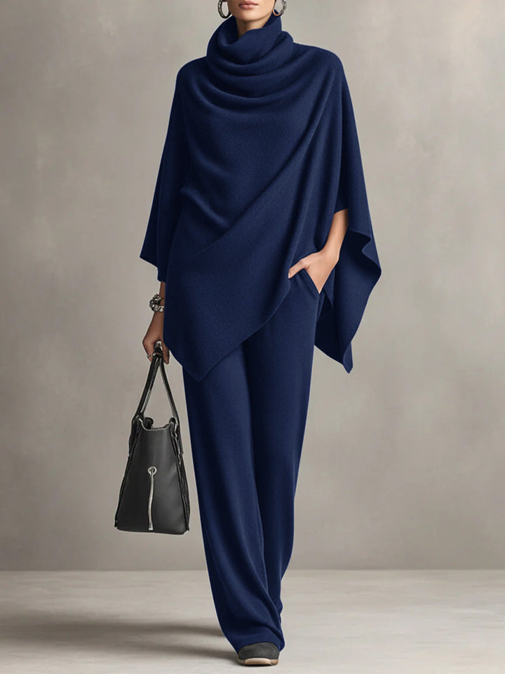 Women's elegant black two-piece set: draped, short-sleeve top paired with flowy wide-leg pants. Sophisticated style.