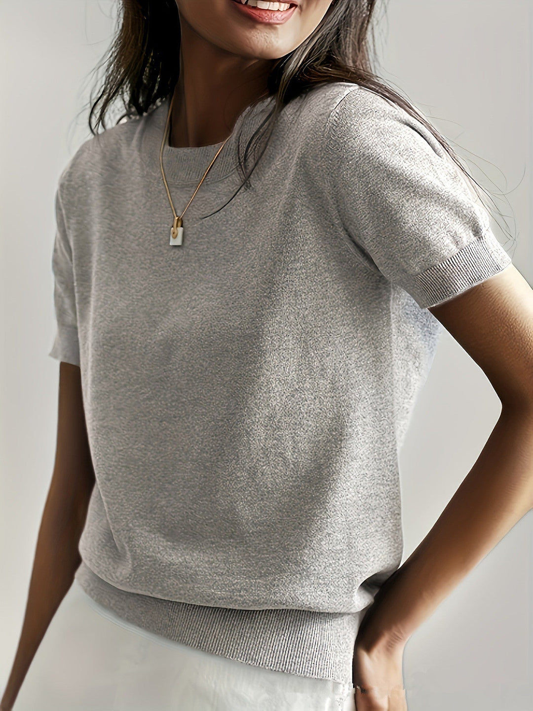 Classic women's short sleeve knit top, offering an elegant and comfortable fit.