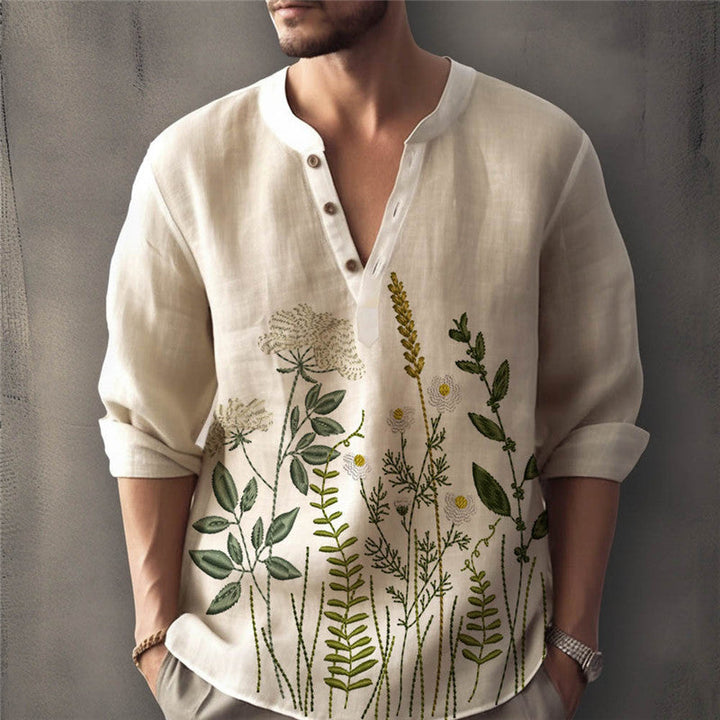Elegant white men's button-down shirt, long sleeve, with vibrant floral embroidery detail. Summer ready.