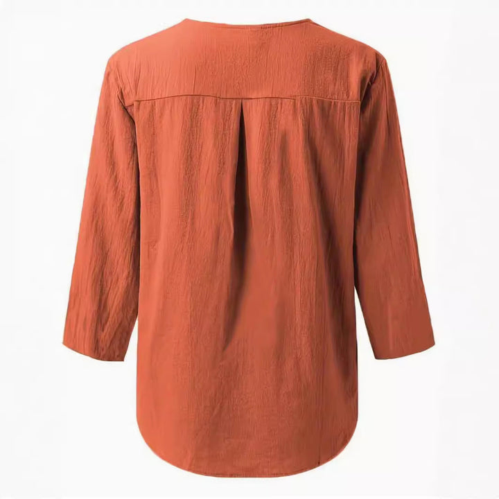 Effortless women's button-down blouse featuring v-neck & 3/4 sleeves. Loose comfortable casual top for any day.