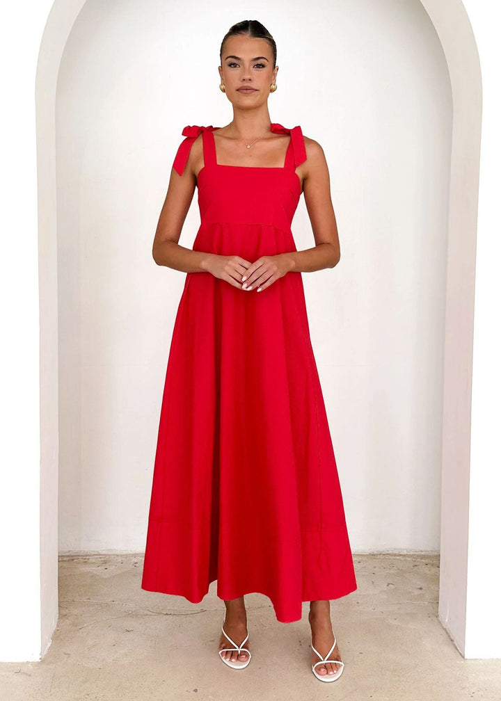 Stunning red women's maxi dress with adjustable straps, offering an elegant and flowy summer look.