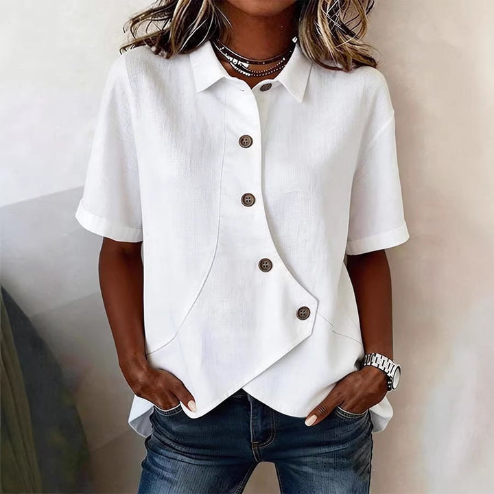 Women's relaxed fit blouse with elegant wavy pattern and distinct button accents, suitable for everyday wear.
