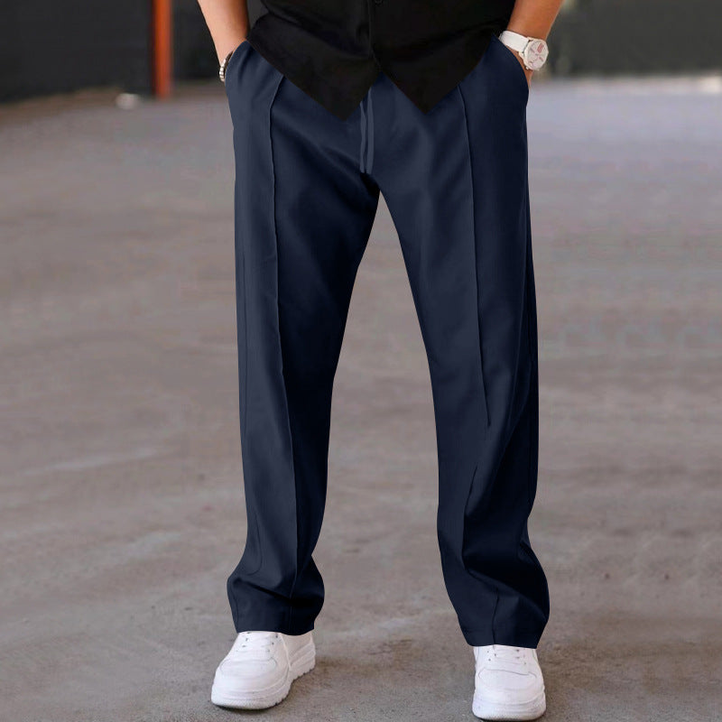 Close-up of soft fabric on men's grey joggers, highlighting comfort & quality for loungewear.
