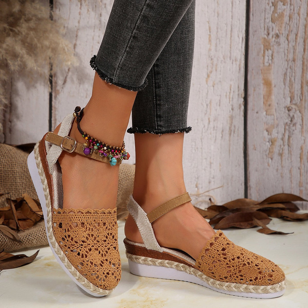 Women's stylish beige espadrille flats with secure ankle straps, great for casual summer outfits.